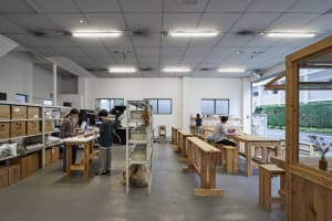 Industrial-style coffee shop with wooden tables and shelves