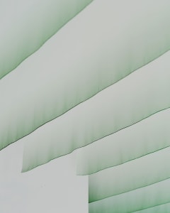White interior with green curtains and drapes