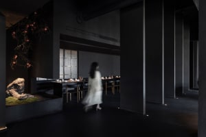 A modern restaurant interior with steel and concrete elements.