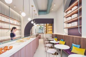 A modern industrial cafe with concrete, wooden, and metallic elements