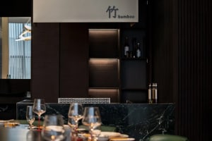 Minimalist restaurant interior featuring marble and wood materials.