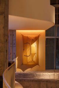 A minimalist installation featuring fabric art elements.