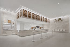 Modern, minimalist coffee shop interior with neutral tones and clean lines.