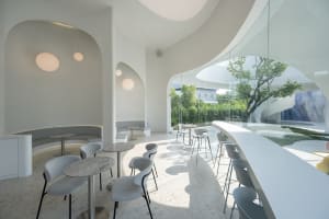 Modern design interior of a coffee shop featuring concrete and glass materials.