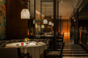 A modern, industrial-themed restaurant with metal, glass, and wooden elements