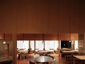 A modern, minimalist restaurant interior with wooden walls and tables, clean lines and open space.