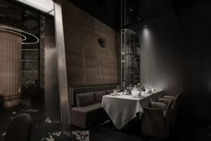 Modern restaurant with metal and wooden structures, glass walls, and elegant table setup
