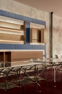 An industrial-style office space featuring a combination of metal, glass, and concrete elements.