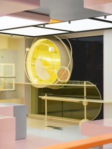 A minimalist retail storefront featuring metal, glass, and neon lights.