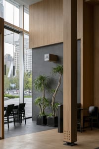 Modern interior design featuring wooden walls, glass windows, and stone tiles