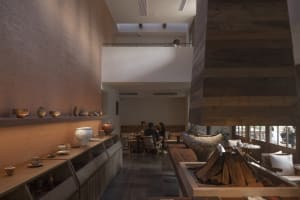 Modern restaurant interior with wooden elements and seating area