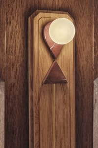 Modern lighting fixture with a combination of wood, marble, and brass materials.