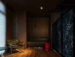 Industrial-style bar area with metal frame chairs, wooden accents, and leather seating.