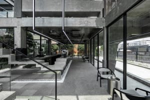 An industrial-style coffee shop with concrete and glass features.