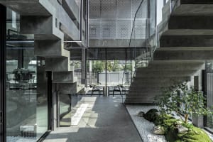 A modern interior space featuring concrete and glass materials.
