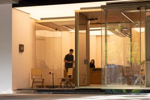 A minimalist coffee shop with glass walls and wooden furniture