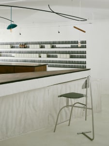 Modern industrial bar with concrete counter and minimalist design.
