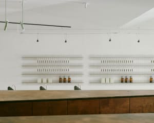 Modern restaurant interior with wooden tables and concrete walls