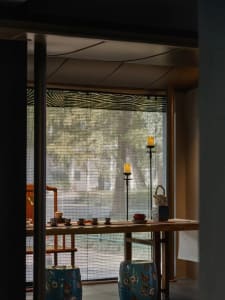 A serene tea room featuring wooden furniture and ceramic tea set