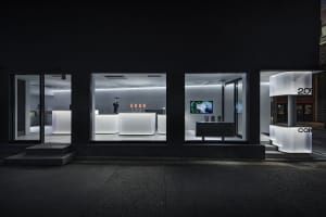 White concrete interior of a modern coffee shop showing sleek design elements.