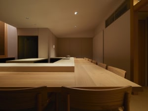 Modern restaurant interior with wooden tables and chairs