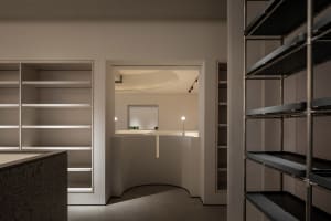 Minimalist retail store with metal and glass elements.