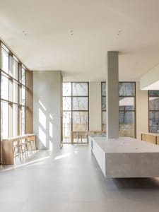 An image of a modern commercial space featuring a combination of concrete and glass materials.