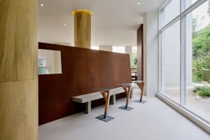 Modern industrial office lounge with concrete, metal, and wood materials.