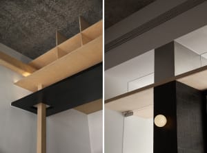 Modern office space featuring wooden partitions, concrete floor, and metal accents.