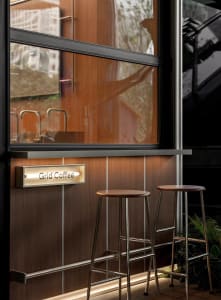 A minimalist coffee bar featuring wooden elements and sleek design.