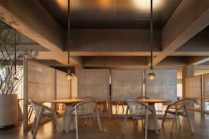 A modern restaurant interior featuring wooden furniture, with a focus on the clean lines and warm tones of the design.