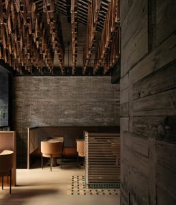 Modern minimalist restaurant interior featuring wooden elements and contemporary design.