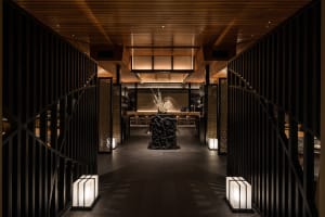 A modern restaurant interior featuring wooden materials and contemporary design elements.