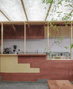 A modern cafe counter featuring wood and concrete materials