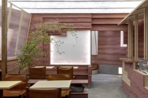 Modern restaurant interior with concrete walls and leather seating