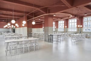 A spacious commercial canteen with modern design elements of concrete and terrazzo