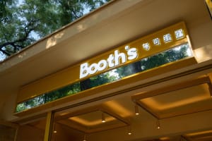 Booth's storefront with a metallic sign
