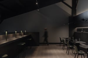 Modern industrial restaurant interior with concrete and wood elements.