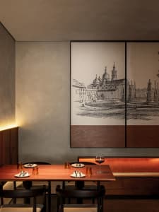 Modern restaurant interior with wooden tables, metal chairs, and glassware.