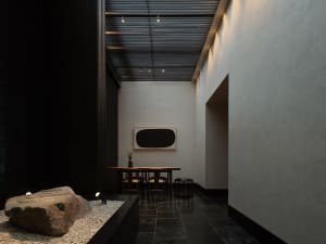 A minimalist indoor space with concrete walls and flooring.
