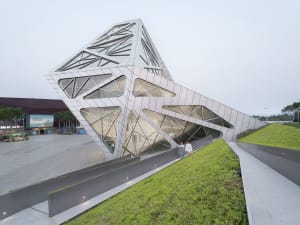 A modern museum with a geometric, metal-clad facade.