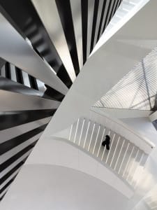 An architectural staircase with metallic white design elements.