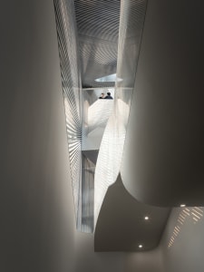 Modern interior featuring a metallic ceiling with geometric patterns.