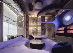 Modern lounge area with glass walls, metal accents, and upholstered furniture.