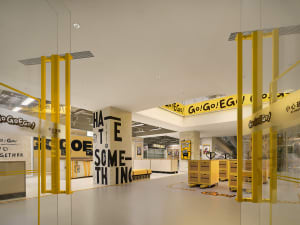 Interior design image of a modern retail space featuring bold yellow accents.