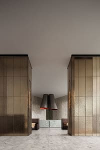 A modern lobby with metallic tiles and marble flooring.