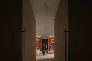 Modern interior with concrete walls and a central table with chairs.
