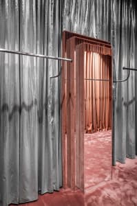 Modern fashion store interior with velvet rails and reflective surfaces
