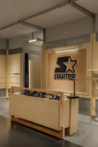 A retail storefront with wooden finishes and a prominent Starter logo.