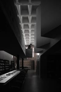 A modern library with a concrete base and open ceiling space.